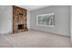 Bright living room featuring a brick fireplace, neutral carpet, and a large bay window at 6704 W Topeka Dr, Glendale, AZ 85308
