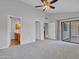 Airy main bedroom with neutral walls, carpet, and sliding door access to an outdoor patio area at 6704 W Topeka Dr, Glendale, AZ 85308