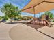 Community playground featuring shade structures, play equipment, and seating areas at 6704 W Topeka Dr, Glendale, AZ 85308