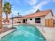 Outdoor living at its finest: backyard pool with covered patio, palm trees and lounge chairs at 6704 W Topeka Dr, Glendale, AZ 85308