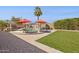 Backyard featuring a pool, outdoor kitchen, lounge chairs, patio, and artificial grass for easy maintenance at 6926 E Culver St, Scottsdale, AZ 85257