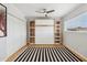 Cozy bedroom featuring hardwood floors, a built-in Murphy bed with ample shelving, and natural light at 6926 E Culver St, Scottsdale, AZ 85257