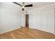 An empty bedroom with hardwood floors and a ceiling fan provides a bright and spacious feel at 6926 E Culver St, Scottsdale, AZ 85257