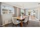 Bright dining room features a wooden table set, modern lighting, and an open doorway to the backyard at 6926 E Culver St, Scottsdale, AZ 85257
