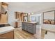 Open kitchen with an island, wood cabinets, stainless steel appliances, and adjacent dining area at 6926 E Culver St, Scottsdale, AZ 85257