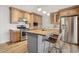 Charming kitchen features stainless steel appliances, gas range, custom cabinets, and an island with seating at 6926 E Culver St, Scottsdale, AZ 85257
