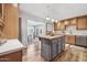 A stylish kitchen features wood cabinets, a gray island with butcher block top, and stainless steel appliances at 6926 E Culver St, Scottsdale, AZ 85257