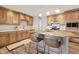 Well-lit kitchen showcasing wood cabinetry, stainless steel appliances, an island, and modern pendant lighting at 6926 E Culver St, Scottsdale, AZ 85257