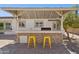 This outdoor kitchen has a stone surround, stainless grill, and bar seating, perfect for outdoor entertaining at 6926 E Culver St, Scottsdale, AZ 85257