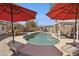 A lovely pool area is surrounded by seating, umbrellas and outdoor kitchen making it the perfect backyard retreat at 6926 E Culver St, Scottsdale, AZ 85257