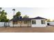 Back exterior view of renovated home featuring a new roof, black accents and a large yard at 7316 W Carol Ave, Peoria, AZ 85345