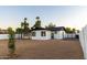 Spacious backyard featuring a newer home with black accents and desert landscaping at 7316 W Carol Ave, Peoria, AZ 85345