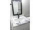 Close up of bathroom vanity featuring a white countertop with stone details and a black faucet at 7316 W Carol Ave, Peoria, AZ 85345