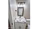 Bathroom vanity featuring white marble countertop, undermount sink, modern faucet and accent lighting at 7316 W Carol Ave, Peoria, AZ 85345