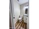 Powder room with wood-look flooring, toilet, and white vanity with black hardware and lighting at 7316 W Carol Ave, Peoria, AZ 85345
