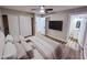 Comfortable bedroom with a ceiling fan, closet, and convenient access to a private ensuite bathroom at 7316 W Carol Ave, Peoria, AZ 85345