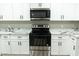 Close-up of new stainless steel oven and cooktop, marble countertops, and white cabinets at 7316 W Carol Ave, Peoria, AZ 85345
