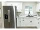 Modern kitchen with white cabinets, stainless steel appliances, and stylish countertops at 7316 W Carol Ave, Peoria, AZ 85345