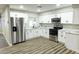 Bright kitchen features white cabinets, stainless steel appliances, and stylish countertops at 7316 W Carol Ave, Peoria, AZ 85345