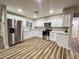 Bright kitchen features white cabinets, stainless steel appliances, and stylish countertops at 7316 W Carol Ave, Peoria, AZ 85345