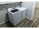 Laundry room features newer white washer and dryer, wood-look flooring and white walls at 7316 W Carol Ave, Peoria, AZ 85345