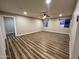 Spacious living room featuring wood-look floors, modern ceiling fan and neutral paint tones for a comfortable atmosphere at 7316 W Carol Ave, Peoria, AZ 85345