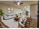 Inviting living room featuring stylish decor, a modern ceiling fan, and an open floor plan at 7316 W Carol Ave, Peoria, AZ 85345
