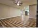 Spacious living room with hardwood floors, a ceiling fan, and access to the kitchen at 7316 W Carol Ave, Peoria, AZ 85345