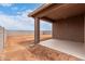 Exterior view of the covered patio and dirt backyard at 7342 E Hackamore Ln, San Tan Valley, AZ 85143