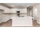 Modern kitchen with white cabinetry, stainless steel appliances, quartz countertops, and a kitchen island at 7342 E Hackamore Ln, San Tan Valley, AZ 85143