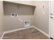 Laundry room with tile floor, shelf, and door at 7342 E Hackamore Ln, San Tan Valley, AZ 85143