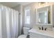 Bathroom featuring a white vanity, toilet, framed mirror, modern fixtures and a shower with a curtain at 7373 E Us Highway 60 -- # 108, Gold Canyon, AZ 85118