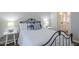 Comfortable bedroom with a black metal bed frame, white bedding, and ensuite bathroom access at 7373 E Us Highway 60 -- # 108, Gold Canyon, AZ 85118