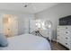 Cozy bedroom featuring wood-look floors, white walls, and access to an ensuite bathroom and closet at 7373 E Us Highway 60 -- # 108, Gold Canyon, AZ 85118