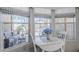 Bright breakfast nook with a white table, blue flowers and large windows overlooking the outdoor seating area at 7373 E Us Highway 60 -- # 108, Gold Canyon, AZ 85118