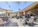 Inviting brick patio with ample seating, barbecue area, and view of surrounding houses at 7373 E Us Highway 60 -- # 108, Gold Canyon, AZ 85118