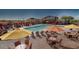 Community pool with lounge chairs, umbrellas, and a clubhouse at 7373 E Us Highway 60 -- # 108, Gold Canyon, AZ 85118