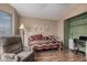 Comfortable bedroom with day bed, laminate flooring, and comfortable recliner at 8500 E Southern Ave # 379, Mesa, AZ 85209