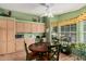 Bright breakfast nook featuring a ceiling fan, wooden table and many windows at 8500 E Southern Ave # 379, Mesa, AZ 85209