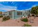 Well-maintained home exterior with blue siding, low-maintenance landscaping, and numerous windows at 8500 E Southern Ave # 379, Mesa, AZ 85209