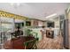 Bright kitchen with wood-look flooring, light wood cabinets, breakfast bar and kitchen island at 8500 E Southern Ave # 379, Mesa, AZ 85209