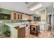 Bright kitchen with wood-look flooring, light wood cabinets and white appliances at 8500 E Southern Ave # 379, Mesa, AZ 85209