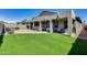 Expansive backyard boasting artificial turf, patios, and outdoor kitchen, creating a great outdoor oasis at 854 S Del Rio Ct, Apache Junction, AZ 85120