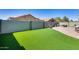 Beautiful backyard featuring green turf, hardscape and outdoor furniture at 854 S Del Rio Ct, Apache Junction, AZ 85120