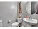 Cozy bathroom with modern fixtures, a pedestal sink, and a toilet, blending functionality with a contemporary touch at 854 S Del Rio Ct, Apache Junction, AZ 85120