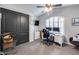 Functional bedroom with ceiling fan, shuttered windows, and a spacious closet, ideal for a home office setup at 854 S Del Rio Ct, Apache Junction, AZ 85120
