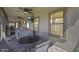 Relaxing covered patio with a hot tub, ceiling fans, and a dining area, offering comfort and style at 854 S Del Rio Ct, Apache Junction, AZ 85120