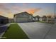 Expansive driveway leading to a well-maintained home with a three-car garage and lush artificial turf at 854 S Del Rio Ct, Apache Junction, AZ 85120