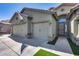 Inviting home featuring a double garage, stone accents, and neutral stucco in a well-maintained suburban neighborhood at 854 S Del Rio Ct, Apache Junction, AZ 85120