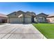 Single-Gathering home featuring desert landscaping, three-car garage and a stone facade at 854 S Del Rio Ct, Apache Junction, AZ 85120